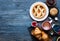 Top view of a wood table full of cakes, fruits, coffee, biscuits