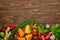 Top view of wooden background with various types of vegetables