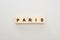 Top view of wooden blocks with Paris lettering on white background.