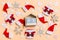 Top view of wooden calendar with Christmas decorations and Santa hats on orange background. The first of January. Happy holiday