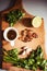 Top view of wooden cutting board with pesto ingredients