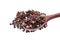 Top view of a wooden spoon full of allspice seeds isolated on white background, shallow depth of field, front focus