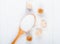 top view of a wooden spoon with white sugar and lump sugar on white background