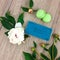 Top view of wooden table with notebook, green macarons and flowers. Flat lat, view from above