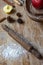 top view of wooden table with red apples, kitchen roll, cinnamon and flour