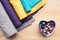 top view of wooden table with rolls of fabric and heart shaped box