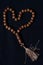 Top View Wooden Tasbih, Love Shape Islam People prayer bead at Black Background