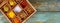 Top view of wooden tray filled with full of ground colorful spices