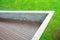 Top View of Wooden Verandah with Green Grass Field Background