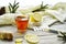 Top view Wooden word sick, Tea with lemon, thermometer, ginger, honey, tablets and dry leaves on a white background