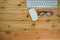 top view of working desk table with keyboard, mouse, glass