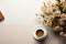 Top view workspace notebook, pen and coffee with plant on wooden table