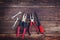 Top view of worn work gloves and assorted work tools over wooden background