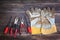 Top view of worn work gloves and assorted work tools over wooden background