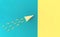 Top view of yellow paper plane with trail of paper clips on trendy aqua and yellow background. Minimalist flat lay image