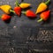 top view of yellow and red hot chili peppers on cracks black background, close up