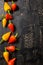 top view of yellow and red hot chili peppers on cracks black background, close up