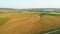 Top view of yellow rural fields on background of hills and villages. Shot. Landscape of agricultural fields on