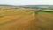 Top view of yellow rural fields on background of hills and villages. Shot. Landscape of agricultural fields on