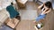 Top view young couple moving carboard boxes in their new house