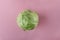 Top view of young fresh cabbage on the pink background.Empty space