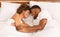 Top view on young loving black couple lying in bed