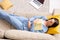 Top view of young restful woman in blue pajamas holding open book on chest