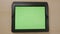 Top view of young woman hands touching tablet pc green screen browsing zooming in and out -