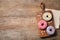 Top view of yummy donuts with sprinkles on table, space for text