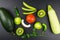 Top view zucchini pepper paprika green beans cucumber tomato kiwi mango pear apple parsley. Black background