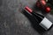 Top viiew of bottle of red wine with blank white label with Christmas decorations on dark background. Wine bottle mockup