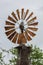 The top of a windmill with a birds nest