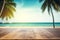 Top of wood table with seascape and palm leaves, blur bokeh light of calm sea and sky at tropical beach background.