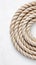 Topdown view of coiled rope on clean white surface