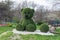 Topiary figures made of grass on the streets of the city.