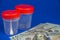 The topic is the cost of a medical examination. Close-up of American dollar banknotes and plastic containers for collecting analyz