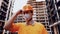 Topic is health protection in production and construction. Caucasian male worker in orange uniform and protective respirator kn 95