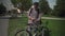 The topic of security and anti-theft lock for a bicycle. A male cyclist locks his bike in a street bike parking lot in a