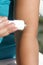 Topical pain of the elbows.  Application of medical ointment on skin in area of elbow.