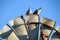 Topknot pigeons perched on top of windmill blade in the late afternoon sun