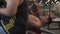 Topless Asian muscular man on workout weight bench lifting heavy dumbbell at gym. male bodybuilder put effort training torso muscl