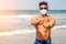 Topless athletic, muscular and healthy black man warm up instructor on the beach.indian male fashion model in mask and