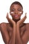 Topless ethnic Black woman moisturizing face