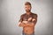 Topless handsome macho man with crossed hands, feeling his strenght and confidence posing at camera. Unshaven young guy with tanne