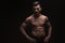 Topless muscular guy posing in dark studio background