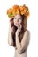 Topless redhead girl with a wreath of colorful flowers on her he