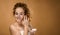 Topless young woman in a studio looking at camera, beauty concept.