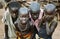 TOPOSA TRIBE, SOUTH SUDAN - MARCH 12, 2020: Boys in tattered dirty clothes looking at camera on blurred background of