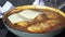 Topping chicken breasts with slices of mozzarella cheese
