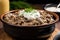 topping off beef stroganoff with a dollop of sour cream